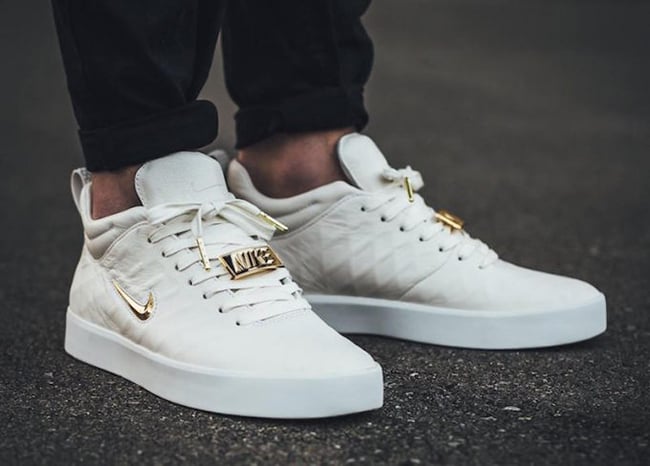 white nike shoes with gold check