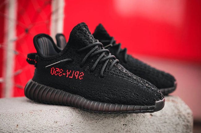 black yeezys red writing