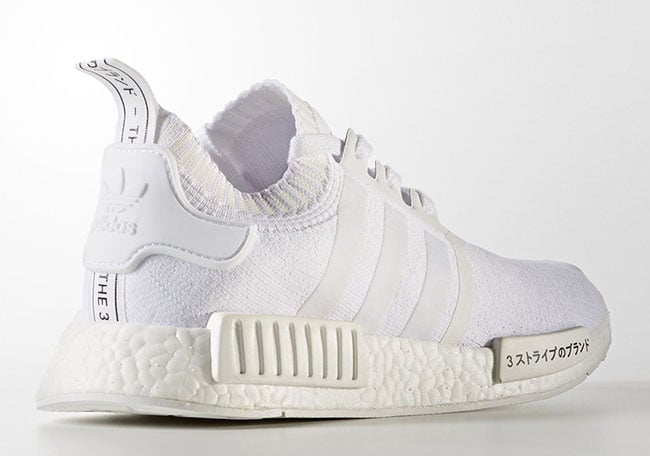white nmds with writing