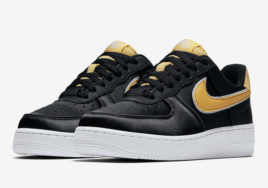 black nike with yellow swoosh