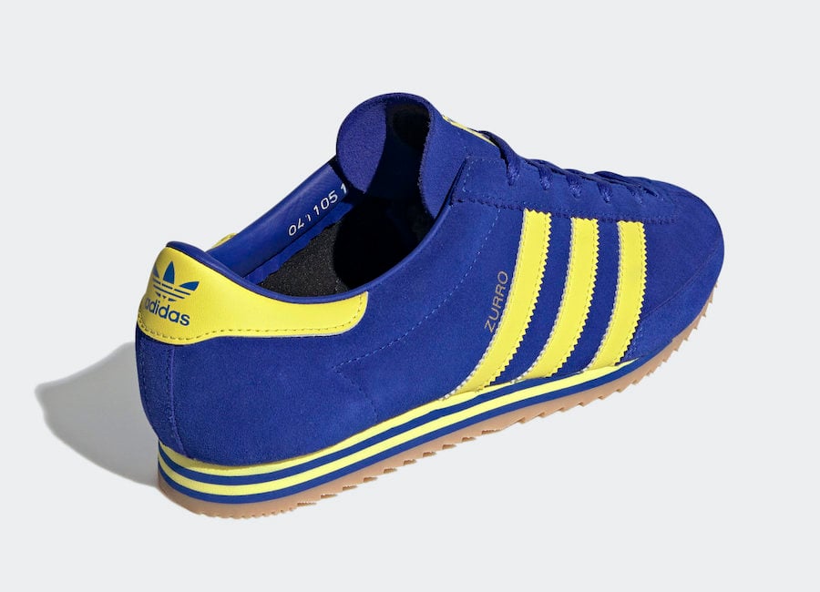 blue adidas yellow stripes